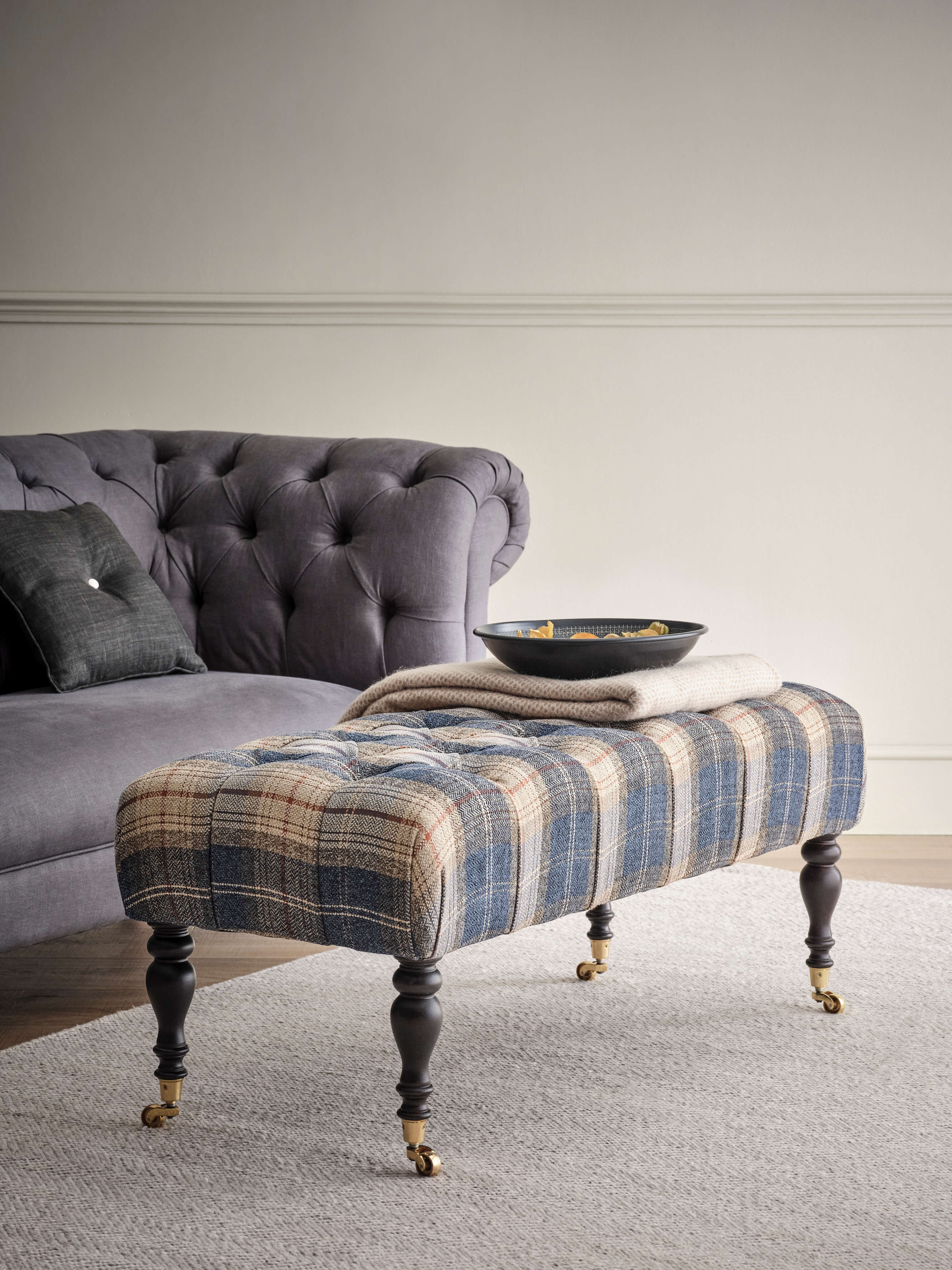 Portland deep buttoned footstool with castors